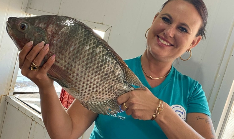 Uma mulher com um peixe nas mãos